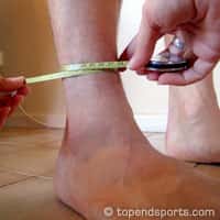 Ankle girth measurement technique showing tape measure placement at narrowest point